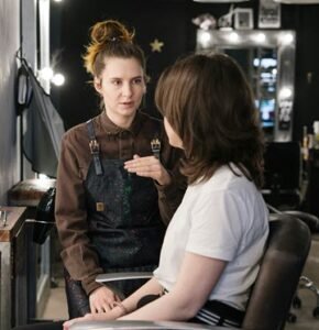 Hairdresser listening to client